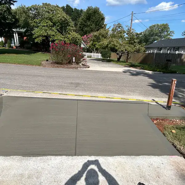 Freshly poured driveway apron meeting the road