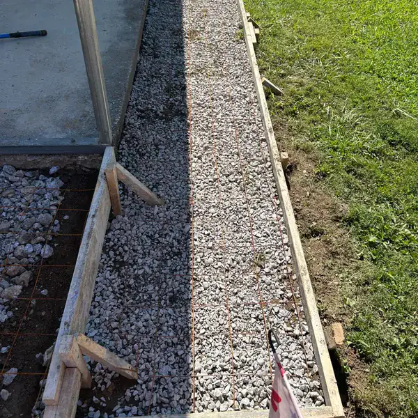 Timber forms and compacted stone along a foundation wall