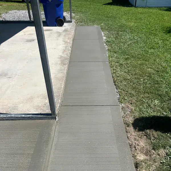Fresh broom-finish walkway running the length of a house