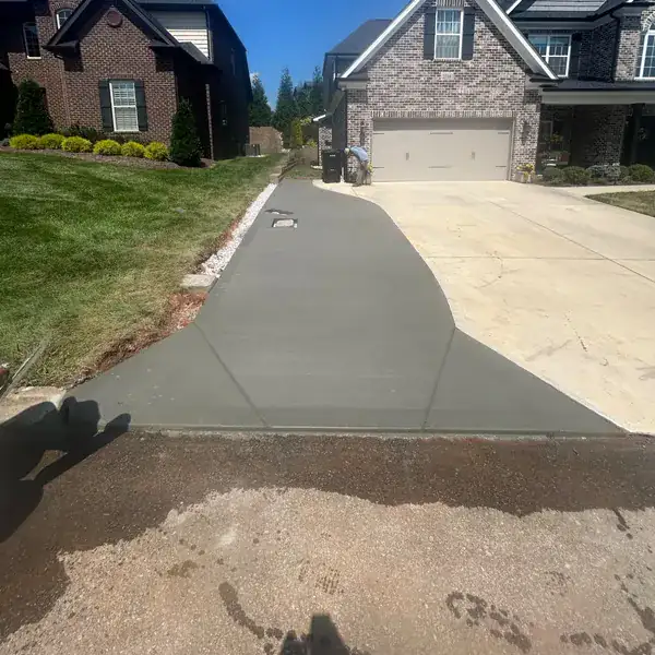 Wide residential driveway poured between two brick homes
