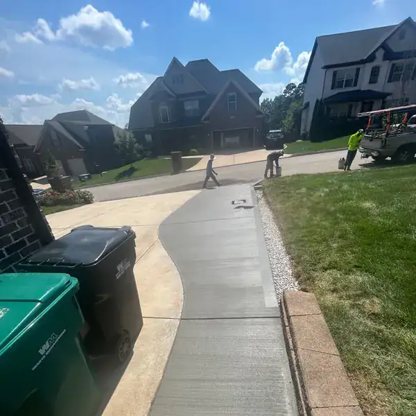 Finished concrete driveway curving up to a house in a Knoxville subdivision