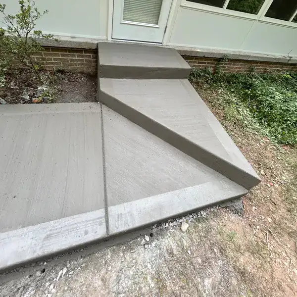 Poured concrete ramp and landing at a residential side entrance
