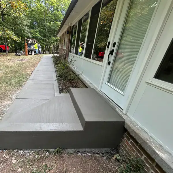 Concrete walkway and step poured along the side of a house