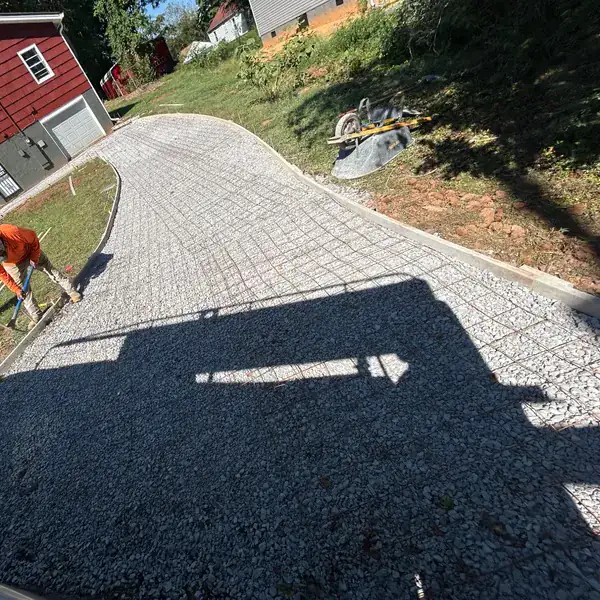 Stamped concrete driveway being finished over a compacted stone base