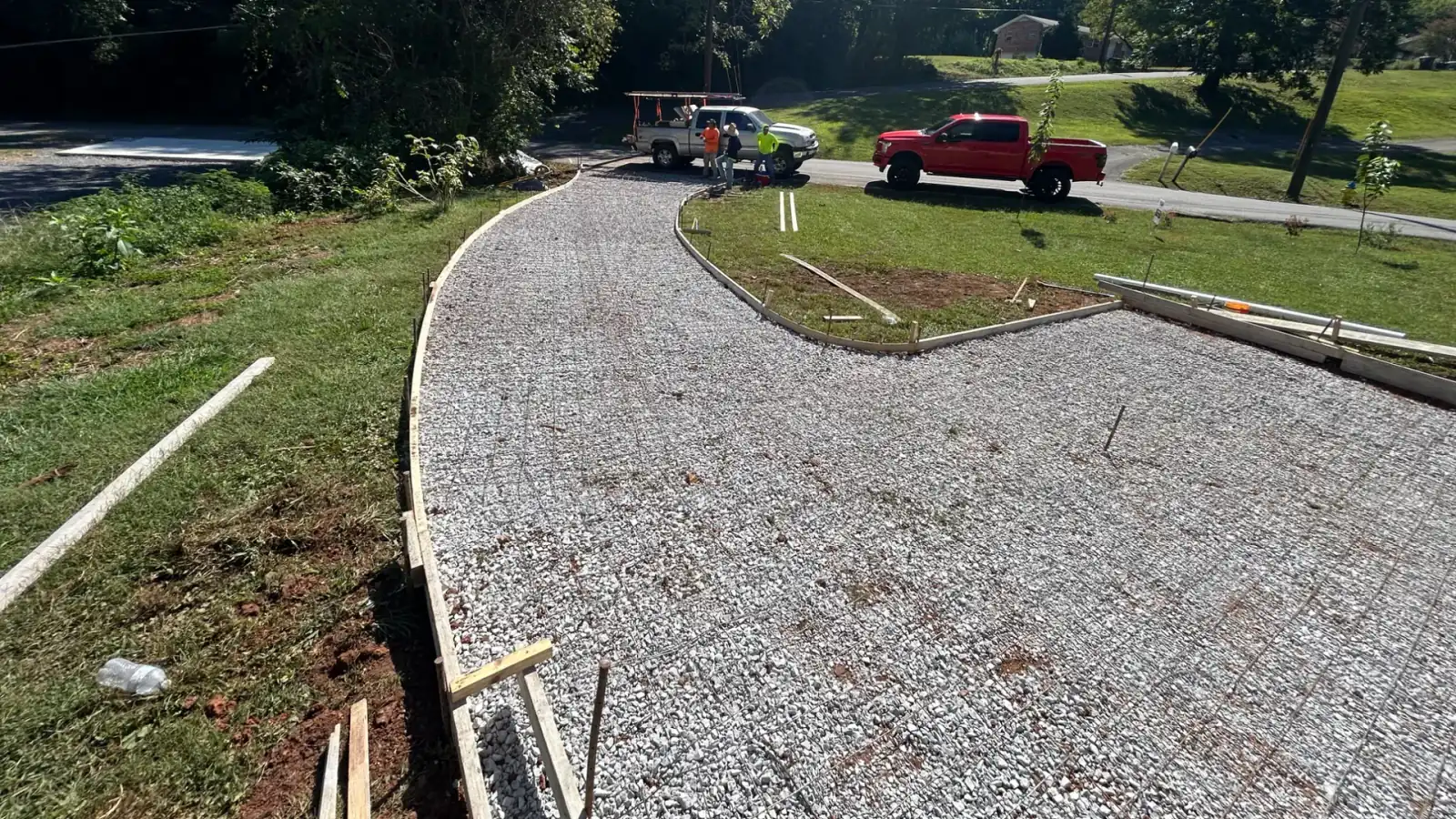 A crushed stone base graded and formed for a new concrete driveway