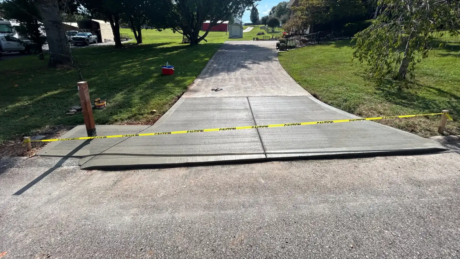 A finished concrete driveway running down to meet the street in East Tennessee