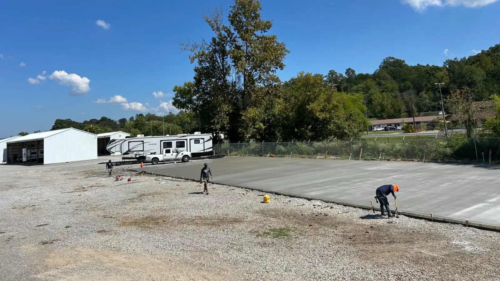 A large commercial concrete pad being poured and finished in East Tennessee